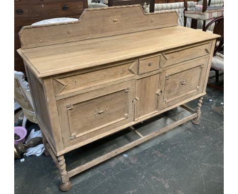 A light oak early 20th century sideboard, two drawers over two doors, with applied geometric mouldings, with handles and fitt