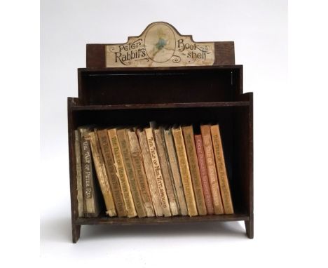 A Peter Rabbit's book shelf, 28x12.5x32.5cmH, with 16 books by Beatrix Potter (af) 