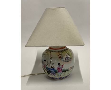 A 20th century Chinese ginger jar converted into a table lamp, depicting court scenes, marked to the base, 35cmH to top of sh