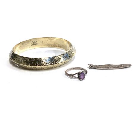 A sterling silver bangle with chased foliate design, approx. 19.9g; together with a silver and amethyst ring, size L etc 