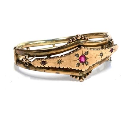 A Victorian 9ct gold hinged bangle, set with rubies and diamonds, hallmarked Chester, D&amp;Co. rd number 456469, approx. 15.