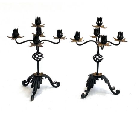 A pair of wrought iron five arm candlestick holders, 37cmH 