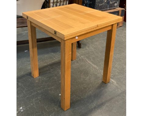 A light oak folding extending kitchen table, 70x70x78cmH (70x140x78cmH when unfolded) 