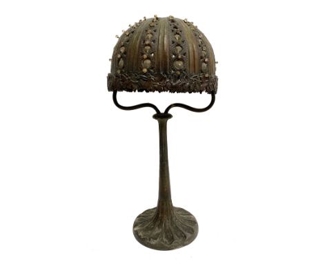 An unusual Art Nouveau table lamp, with metal pierced shade with interwoven cut glass beads and mistletoe design to rim, with