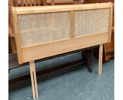 A light oak and caned double headboard 