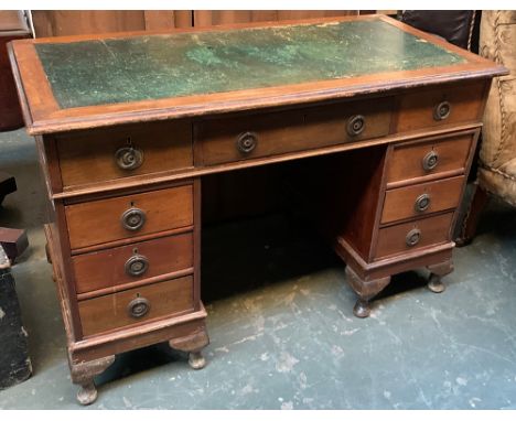 A Victorian light mahogany kneehole pedestal desk, green skiver over traditional arrangement of nine drawers, on cabriole fee