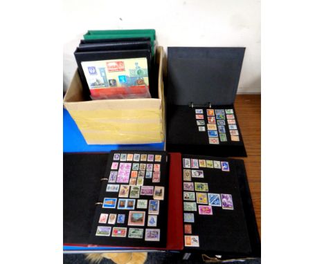 A box containing six folders containing a large quantity of world stamps and first day covers.