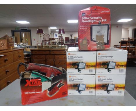 Four Kingavon LED security flood lights together with a further security flood light and an electric sander