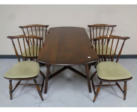 An Ercol elm and beech drop leaf table together with a set of four chairs 