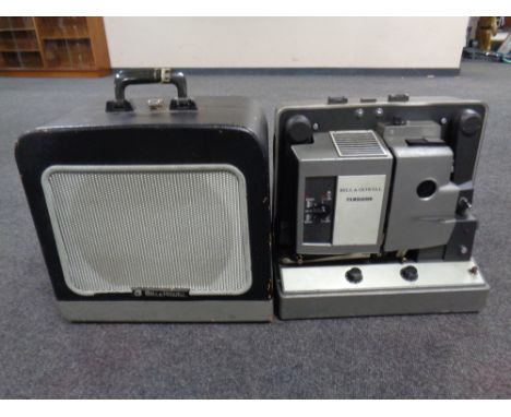 A Bell &amp; Howell projector in case and a speaker in case (2)