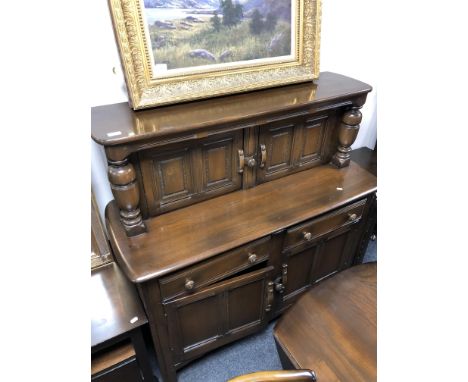 An Ercol elm and beech buffet backed sideboard 