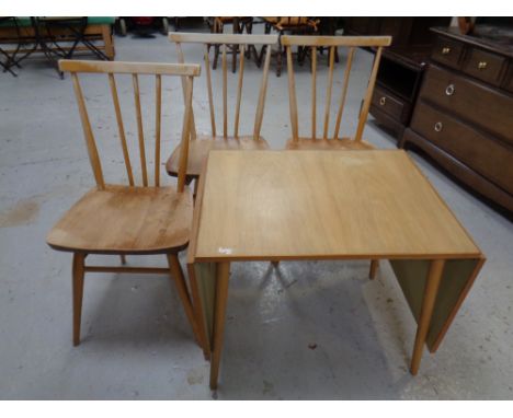 A set of three Ercol elm and beech spindle back dining chairs together with a 20th century flap sided coffee table 