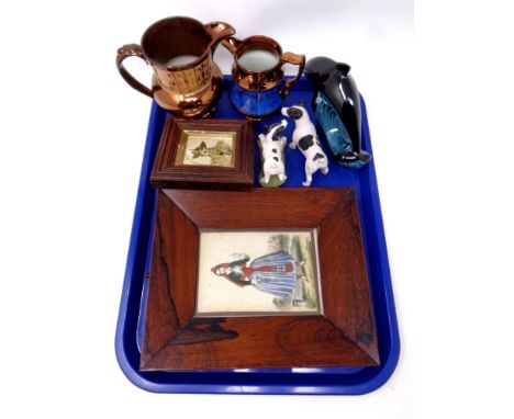 A tray containing copper lustre jugs, pottery dolphin, two dog statues, a hand coloured print of a lady in traditional dress 