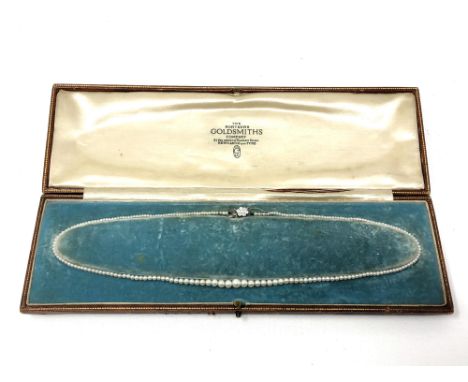 A single strand cultured pearl necklace on platinum and 18ct white gold diamond set clasp, length 44cm. 