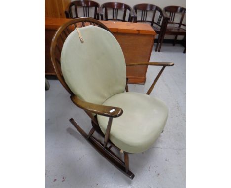 An Ercol elm and beech rocking chair in an antique finish 