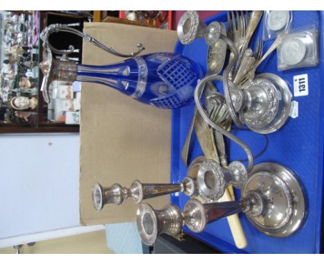 Blue Flask Glass Claret Jug, candlesticks, cutlery, coinage:- One Tray. Canteen of fish knives and forks.