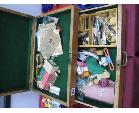 An Oak Sewing Box and Contents, including tape measures, vintage button hooks, needle cases etc.