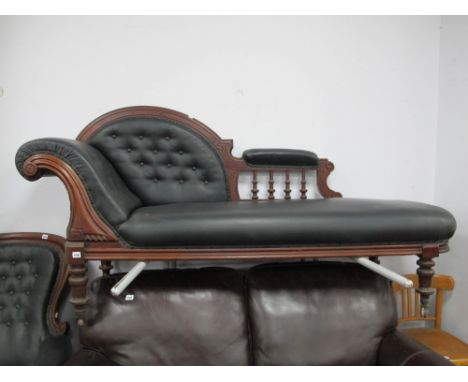 A XIX Century Mahogany Chaise Longue, with high carved back, re-uphostered in a black button back leather.