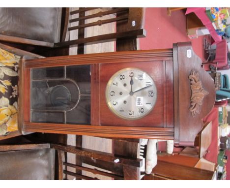 A XX Century Mahogany Wall Clock, with a silver dial, Arabic numbers, glazed leaded door.