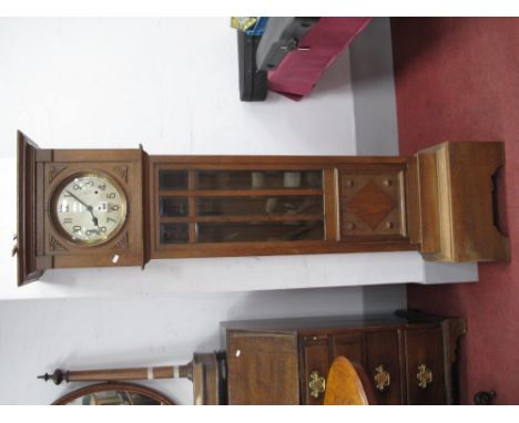 An Early XX Century Oak Eight Day Musical Longcase Clock, with a Silver dial, Arabic numbers, glazed door, with lozenge panel