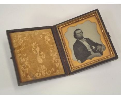 AMBROTYPES.
A 19th century ambrotype portrait of a seated gentleman. 8 x 7cm. Stamped leather case.