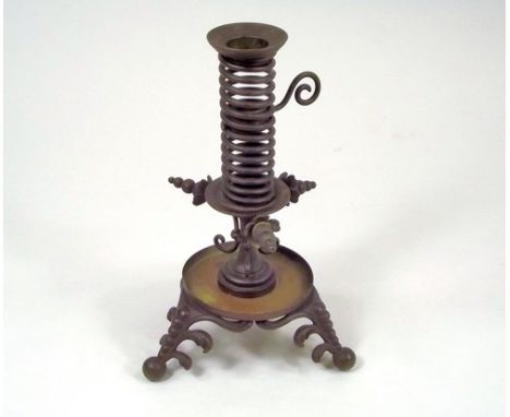 EJECTOR CANDLESTICK.
A 19th century patinated brass ejector candlestick on tripod base, height 20cm.