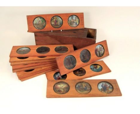 MAGIC LANTERN SLIDES.
36 coloured magic lantern slides, of Biblical scenes, in a stained pine box.