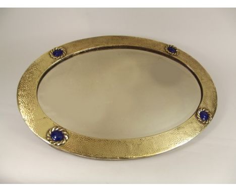 MIRROR.
An early 20th century brass mirror, with blue enamelled roundels.
51 x 72cm.
PLEASE NOTE:  Our in-house, postal shipp
