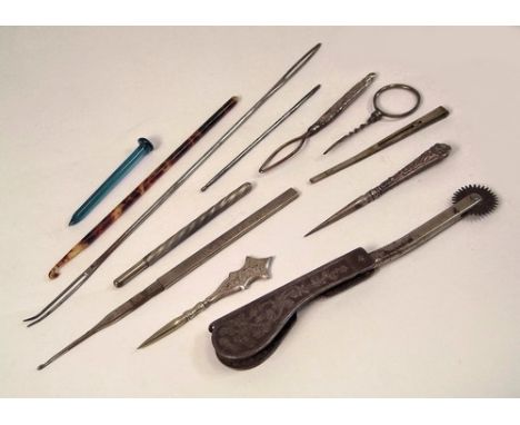 MISCELLANEOUS.
A folding tracing wheel, stilettos, a button hook, crochet hooks etc.