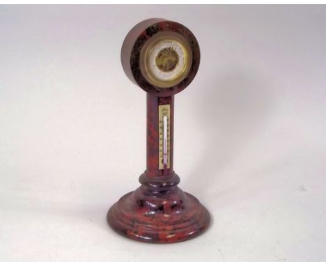 CORNISH SERPENTINE.
A red, turned Cornish Serpentine barometer/thermometer. Height 24cm.