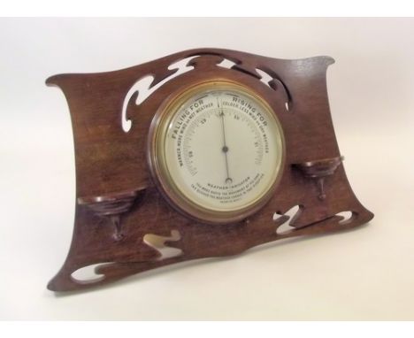 BAROMETER.
A barometer in pierced oak, Art Nouveau surround, with miniature shelf brackets. Max. width 57 cm. Height 32cm.
PL