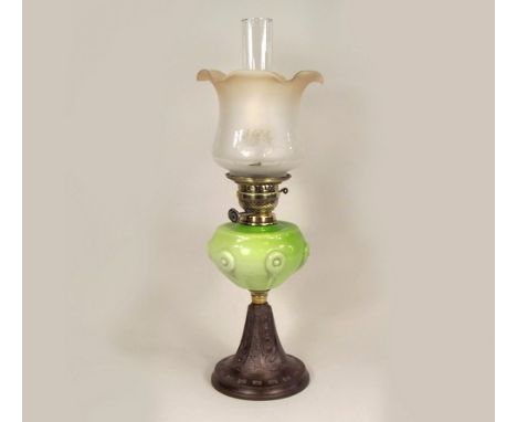 OIL LAMP.
A Victorian oil lamp with green tinted glass fount & cast iron base. Height 62cm.
PLEASE NOTE:  Our in-house, posta