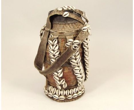 AFRICAN WATER CARRIER.
An African gourd water carrier, decorated with leather, cowrie shells & basket weave. Height 29cm.