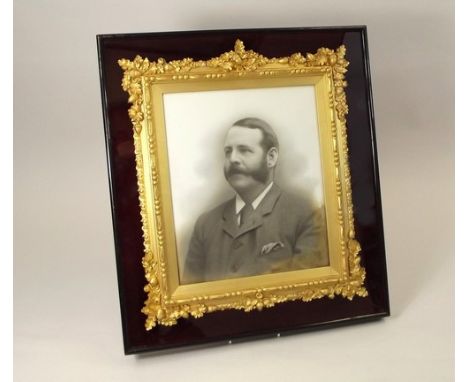 PORTRAIT FRAME.
A late Victorian 'acorn ormolu' portrait frame, set within a glazed case. 47 x 41cm.