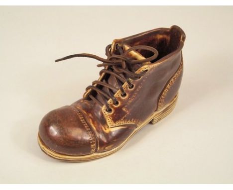 NOVELTY BOOT.
An early 20th century novelty ceramic boot with leather laces. Length 11cm.