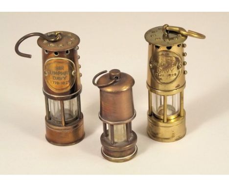 MINIATURE DAVY LAMPS.
Two commemorative Sir Humphry Davy miner's lamps, 7.5cm & one other smaller lamp model.