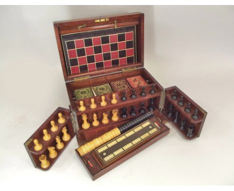 GAMES COMPENDIUM.
An Edwardian mahogany games compendium by F.H. Ayres, with pieces for playing chess, cribbage, draughts, br