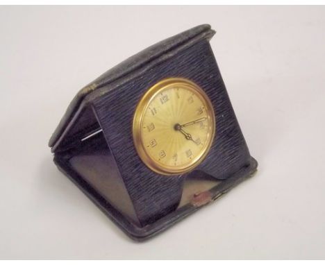 TRAVELLING CLOCK.
An Edwardian leather cased travelling bedside clock.