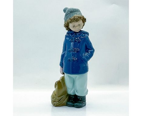 Glossy finish. Nao backstamps. Boy in a blue winter coat with travel bag. Dimensions: 2.5"L x 3"W x 7.25"HManufacturer: Nao b