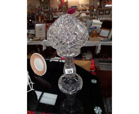 A 1930's heavy cut glass table lamp. Height 35cm.Small nibble on base and a few flea bite nibbles to bottom of rim and a chip