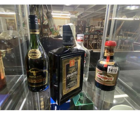 4 Bottles including Smirnoff Vodka, Amaretto, Drambuie and Napoleon Brandy.