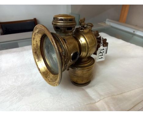 A 'Revenge' brass cycle lamp by Powell &amp; Hammer.
