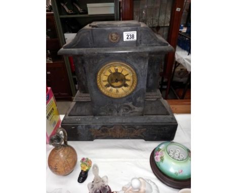 A large black slate mantle clock with brass ormolu embellishments, no key, no pendulum,  springs ok