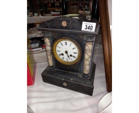 A black slate mantle clock with marble columns, no key, no pendulum, both springs ok, missing finger