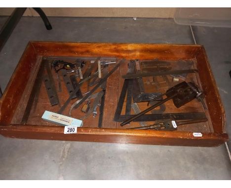 A tray of vintage engineering tools.