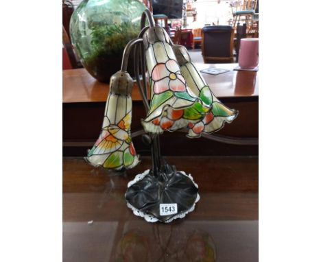 A bronzed white metal lily pad Tiffany style lamp.