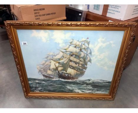 A large gilt framed print of 2 Galleon sailing ships.