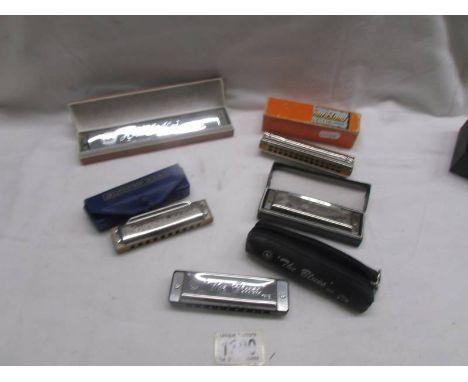 Three Hohner harmonica's and two others.