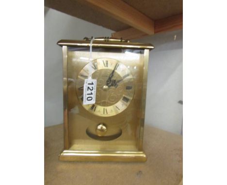 A brass quartz clock by H Samuel.