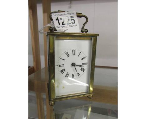 A brass carriage clock.